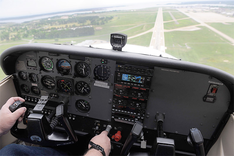 The view from the left seat of a Cessna 172 Skyhawk cockpit on final approach, runway ahead